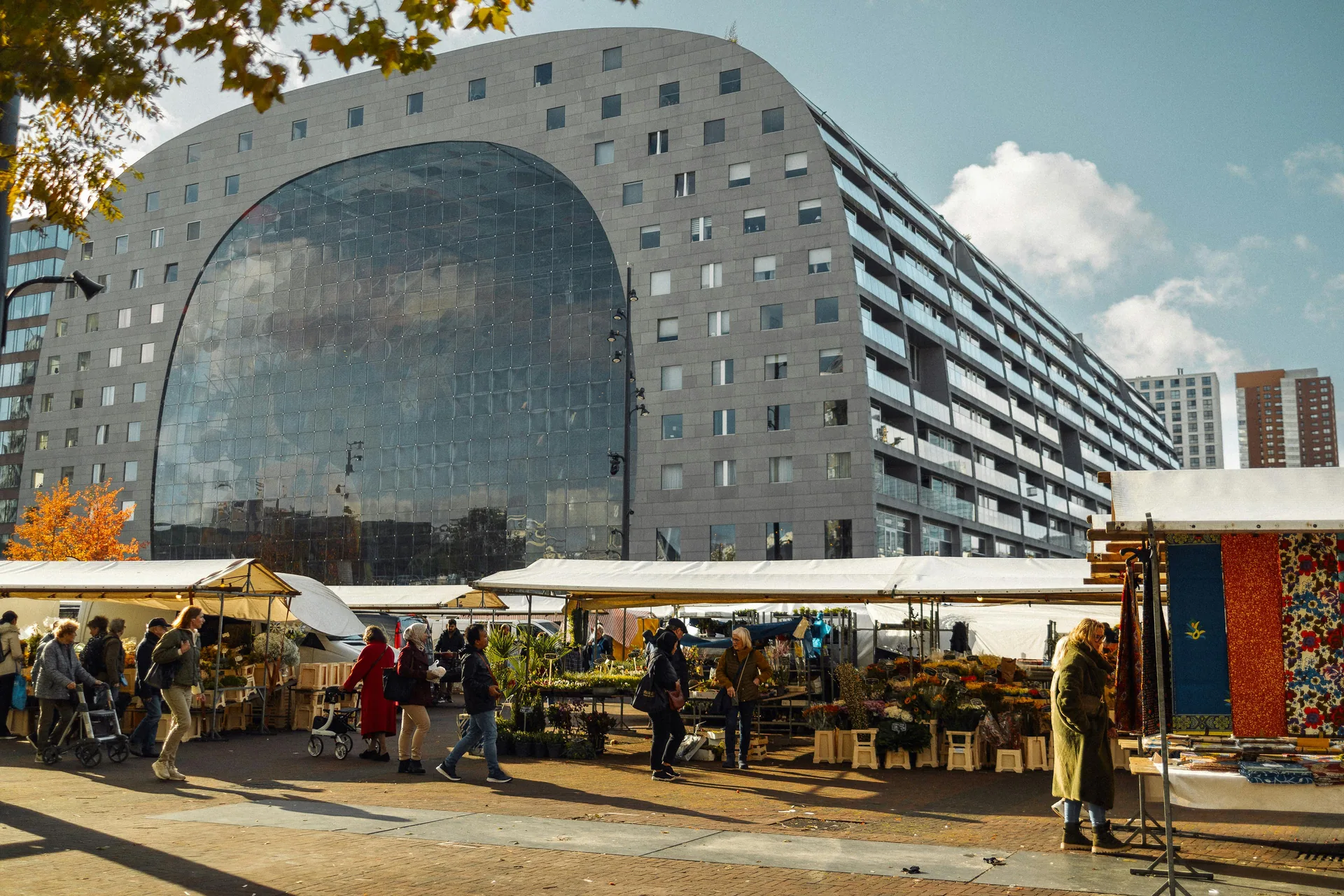 The Markthal in Rotterdam with an outdoor flower market in front